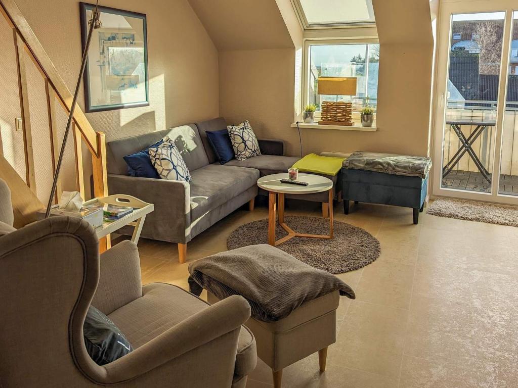 a living room with a couch and chairs and a table at Comfortable holiday home in nature in Schönberg