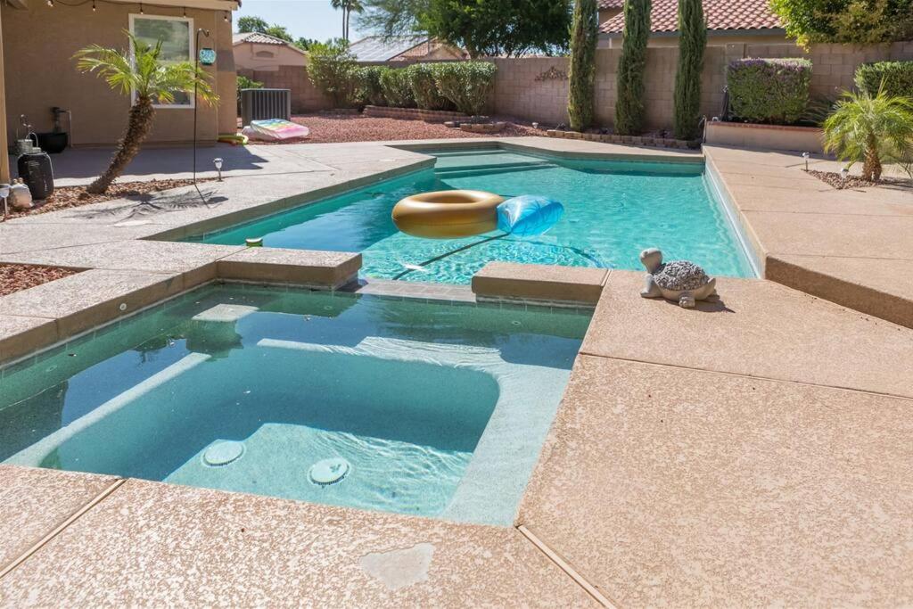 a swimming pool with a toy turtle and a raft at Private paradise with pool heater, spa, billiards in Avondale