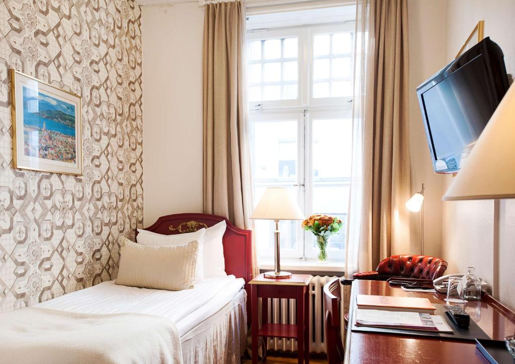 Postel nebo postele na pokoji v ubytování Hotel Kung Carl, WorldHotels Crafted