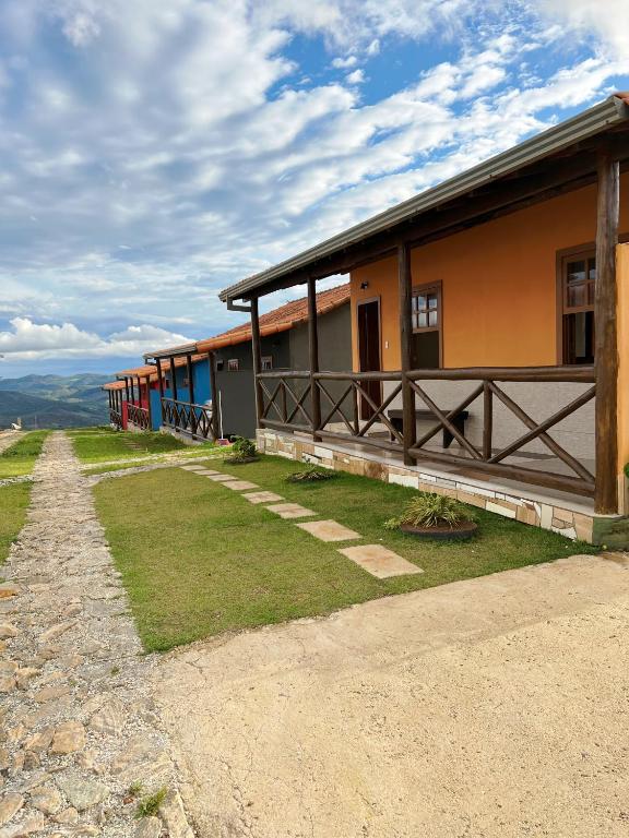 a train is parked next to a building at Pousada Paraíso in Lavras Novas