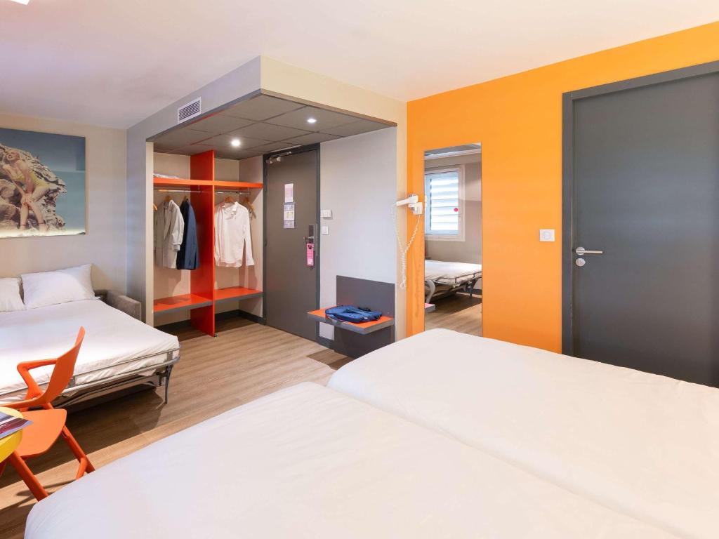 Postel nebo postele na pokoji v ubytování ibis Styles Lyon Centre Confluence