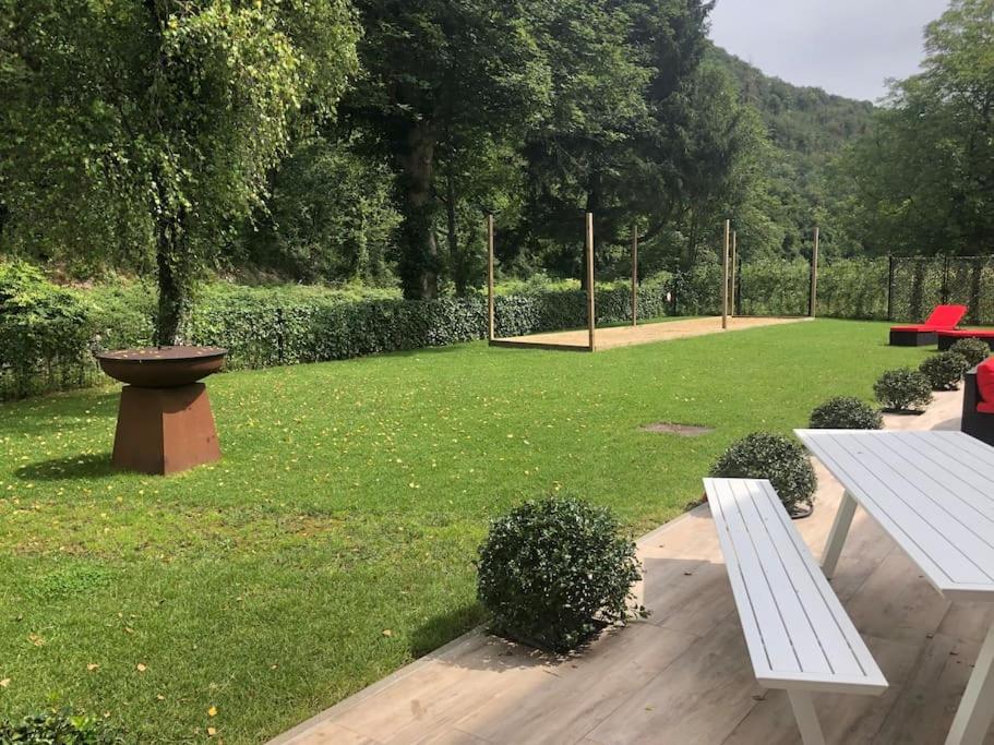 a park with a bench and a field of grass at Maison bord de rivière calme jaccuzi in Trooz