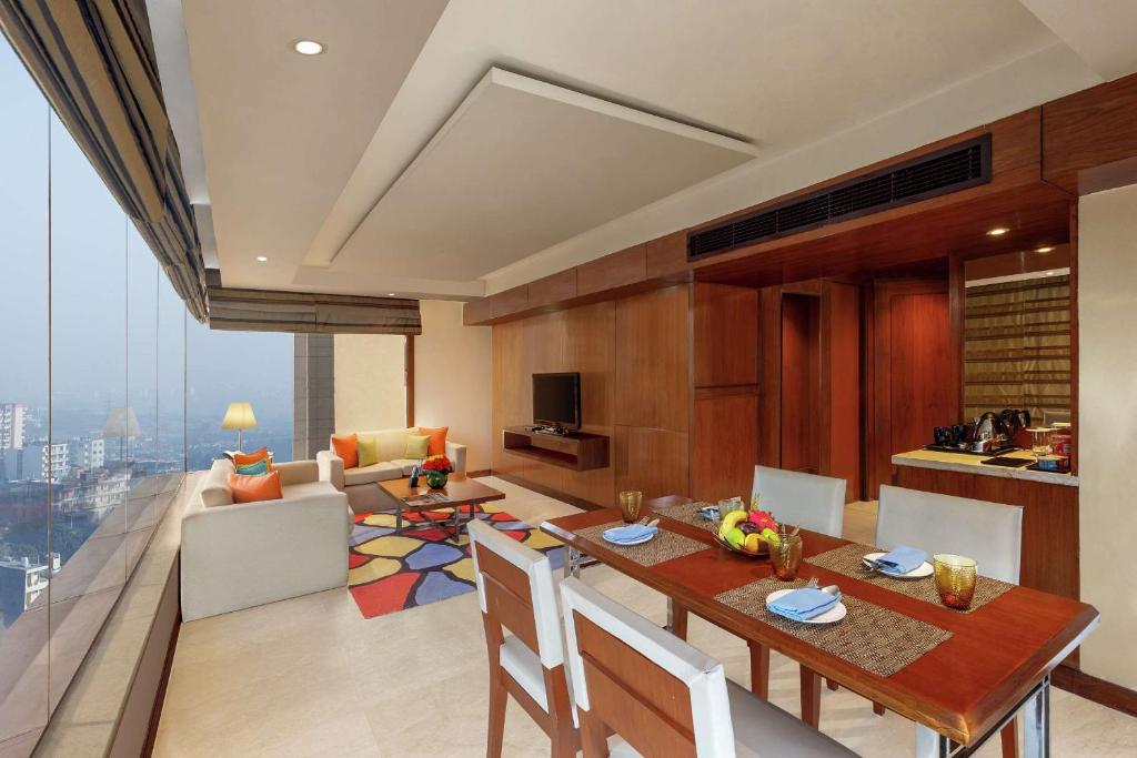 a kitchen and living room with a table and chairs at DoubleTree by Hilton Gurgaon New Delhi NCR in Gurgaon