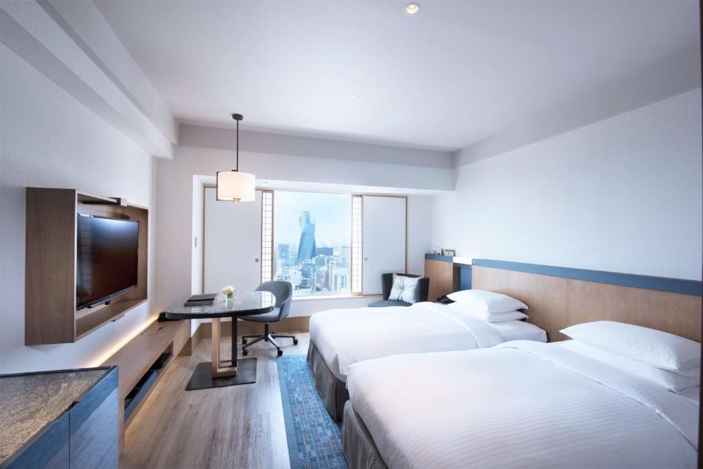 Postel nebo postele na pokoji v ubytování Hilton Nagoya Hotel