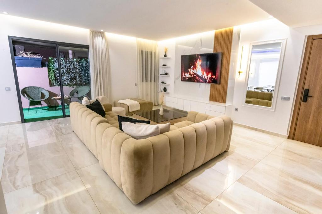 a large living room with a couch and a tv at Luxury Duplex 3 Suites -Front Pool-Direct Pool Access in Marrakesh