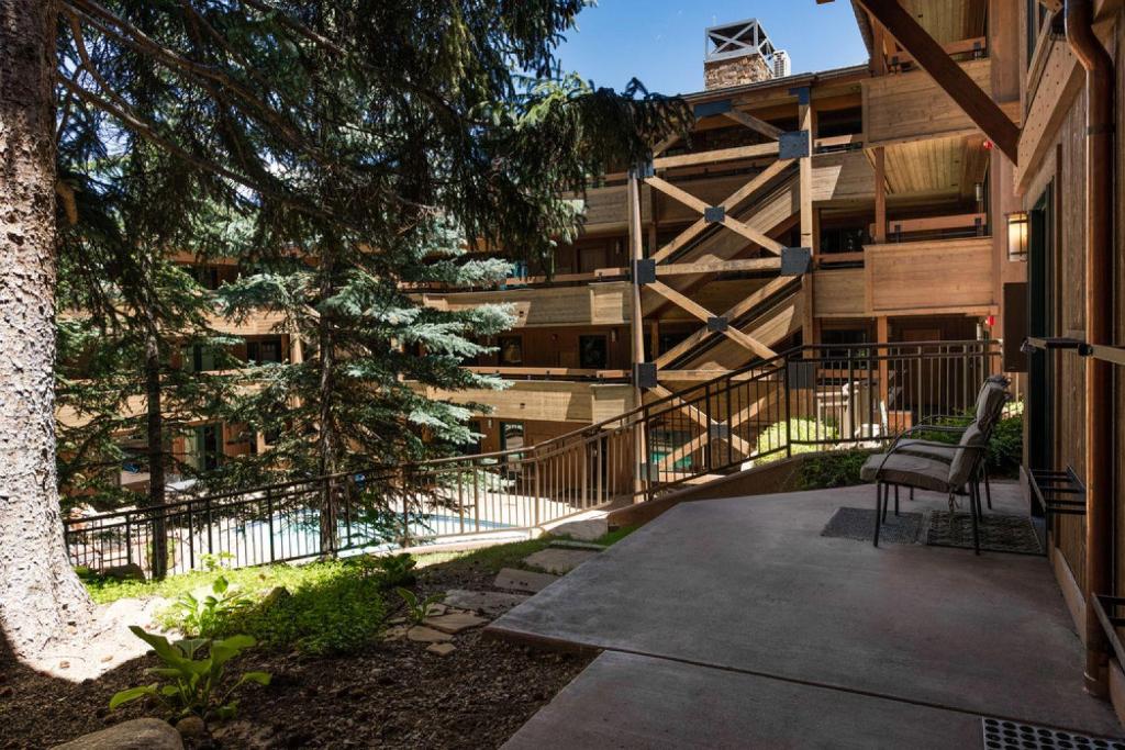 a chair sitting on a sidewalk in front of a building at Aspen Condo W Pool, Hot Tub & 2 Blocks To Gondola - Fh4 in Aspen