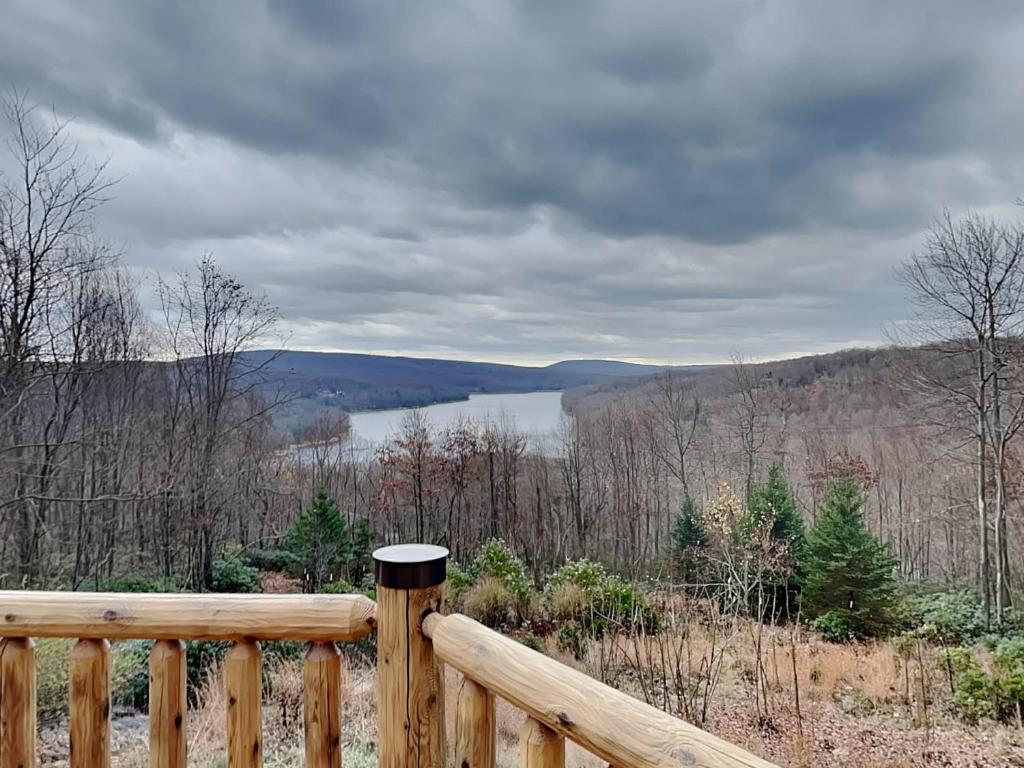 a view of a lake from a wooden railing at Highlands Heaven in McHenry