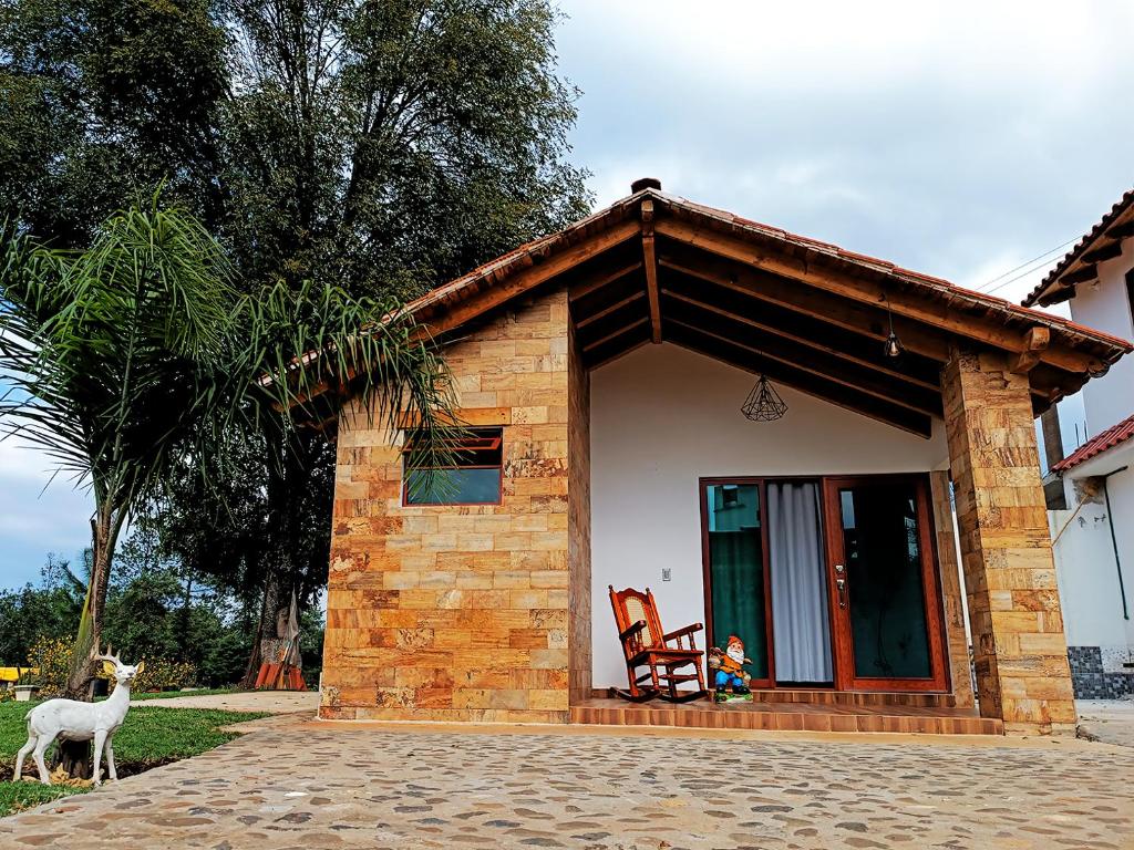 a small house with a goat standing in front of it at Cabaña para pareja en huasca in Huasca de Ocampo
