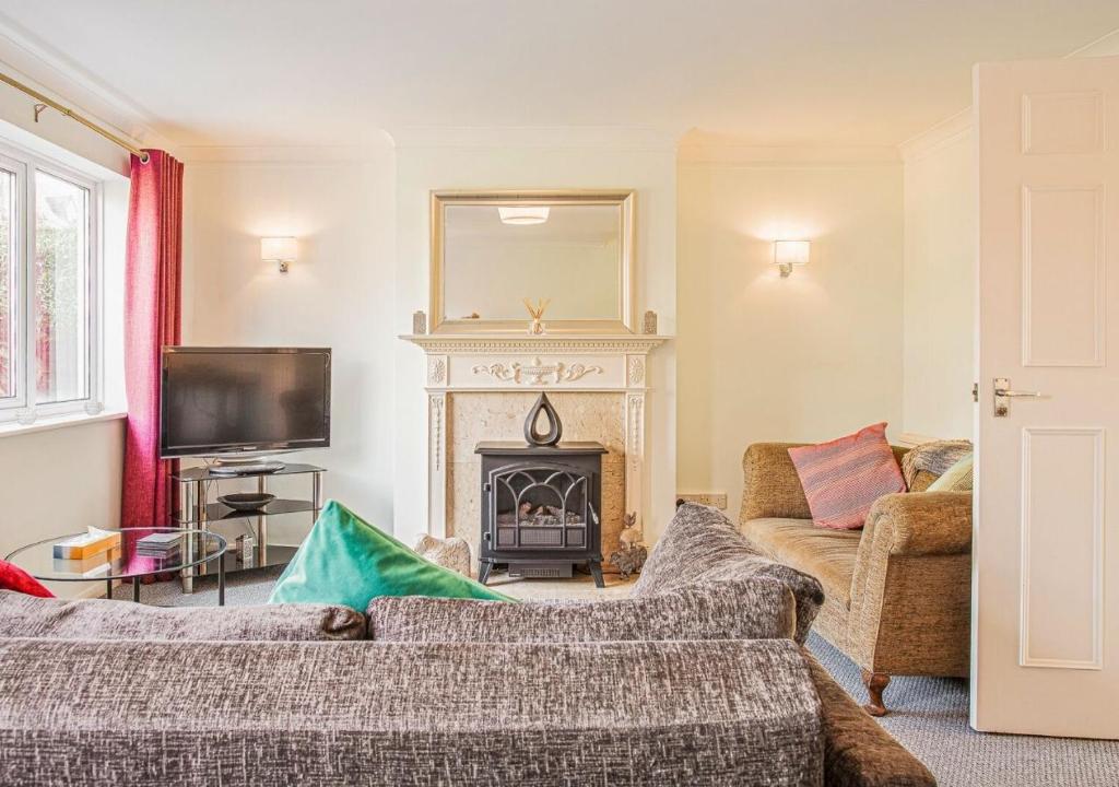 a living room with a couch and a fireplace at Central 2 Bed House w/ Garden and Free Parking! in Cheltenham