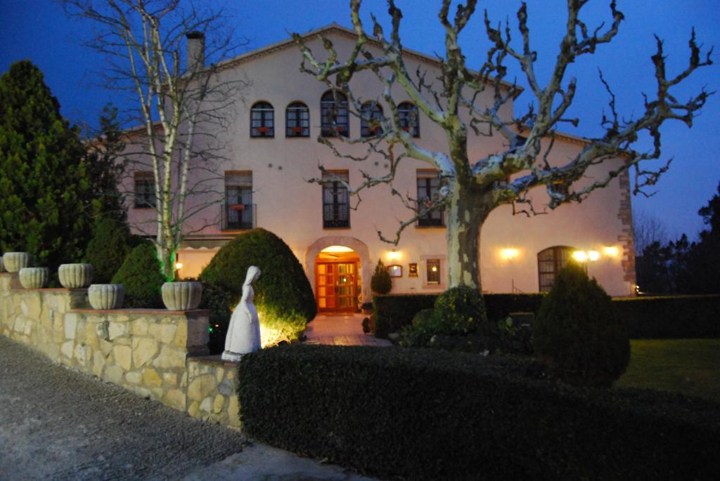 a large white house with a bride in front of it at Masia Del Cadet in Espluga de Francolí