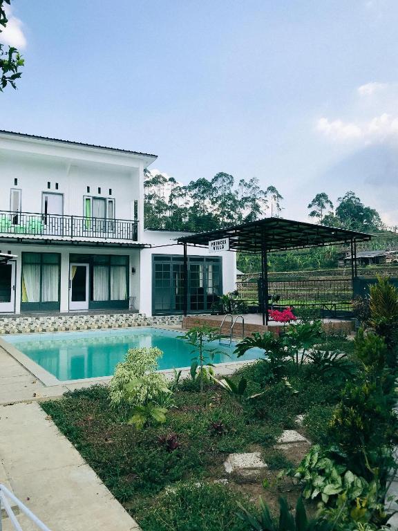 a house with a swimming pool in front of it at Princess Villa in Pasirjambu