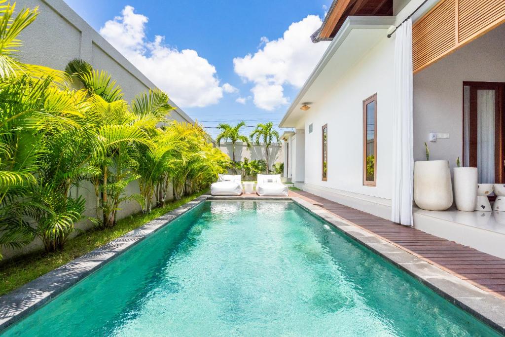 an infinity pool in the backyard of a villa at Villa Gaia Canggu in Canggu