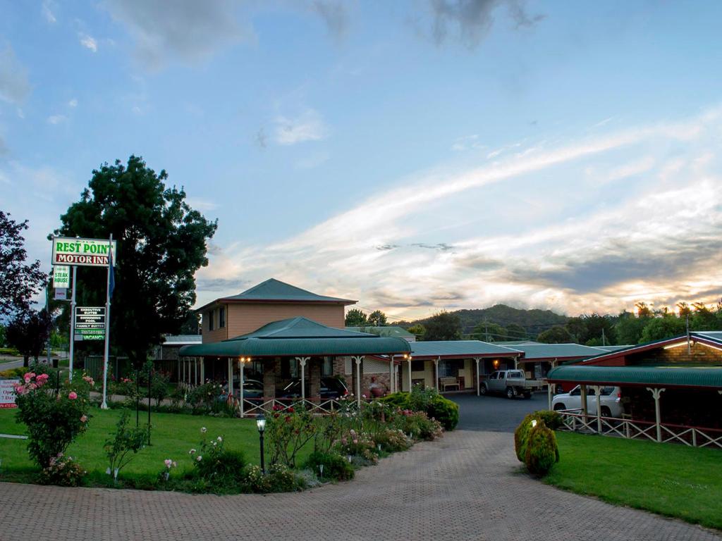 a restaurant with a sign in front of a building at Rest Point Motor Inn in Glen Innes