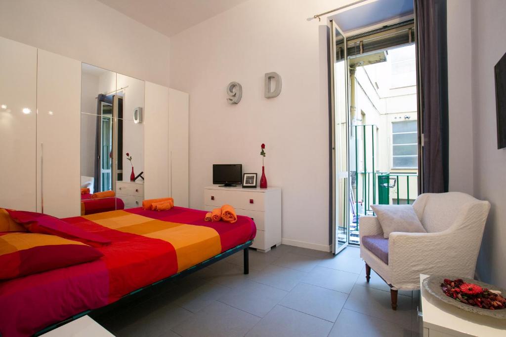 a bedroom with a bed and a chair and a window at Alloggio Turistico Cadorna - Fontana di Trevi , Via Veneto Piazza di Spagna in Rome