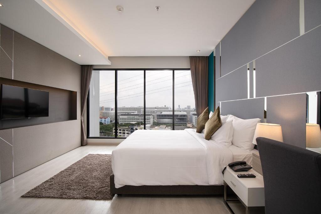 Postel nebo postele na pokoji v ubytování Thaya Hotel Bangkok