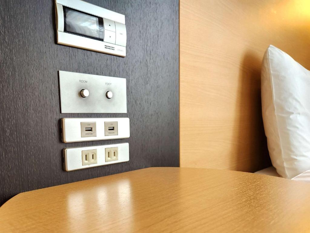 Postel nebo postele na pokoji v ubytování Comfort Hotel Naha Prefectural Office