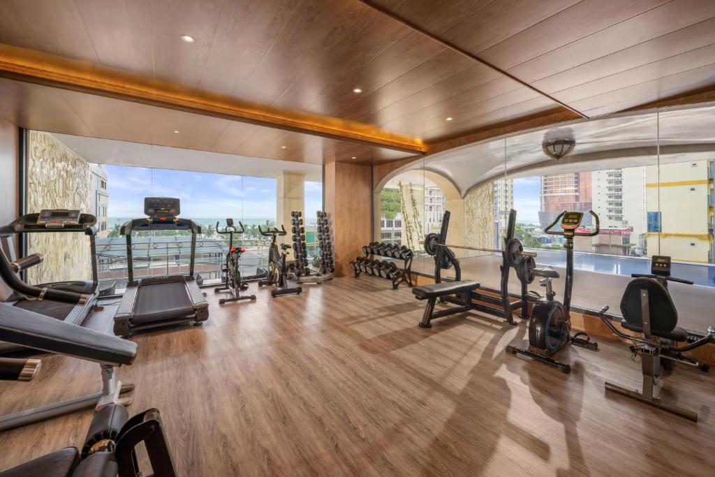 A bright, window-lined gym overlooking the surrounding city buildings.