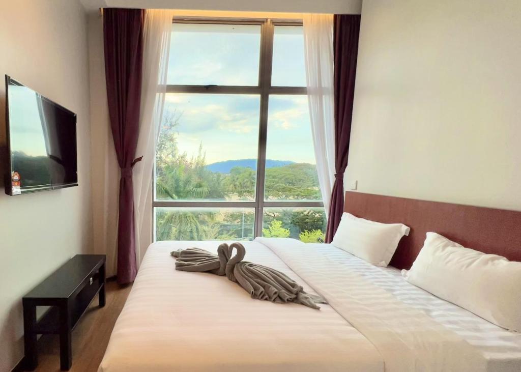 Postel nebo postele na pokoji v ubytování Margo Hotel Kota Kinabalu