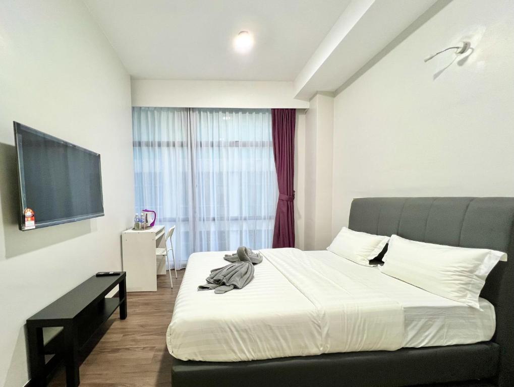 Postel nebo postele na pokoji v ubytování Margo Hotel Kota Kinabalu