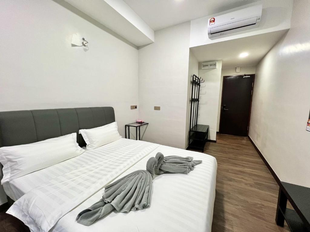 Postel nebo postele na pokoji v ubytování Margo Hotel Kota Kinabalu