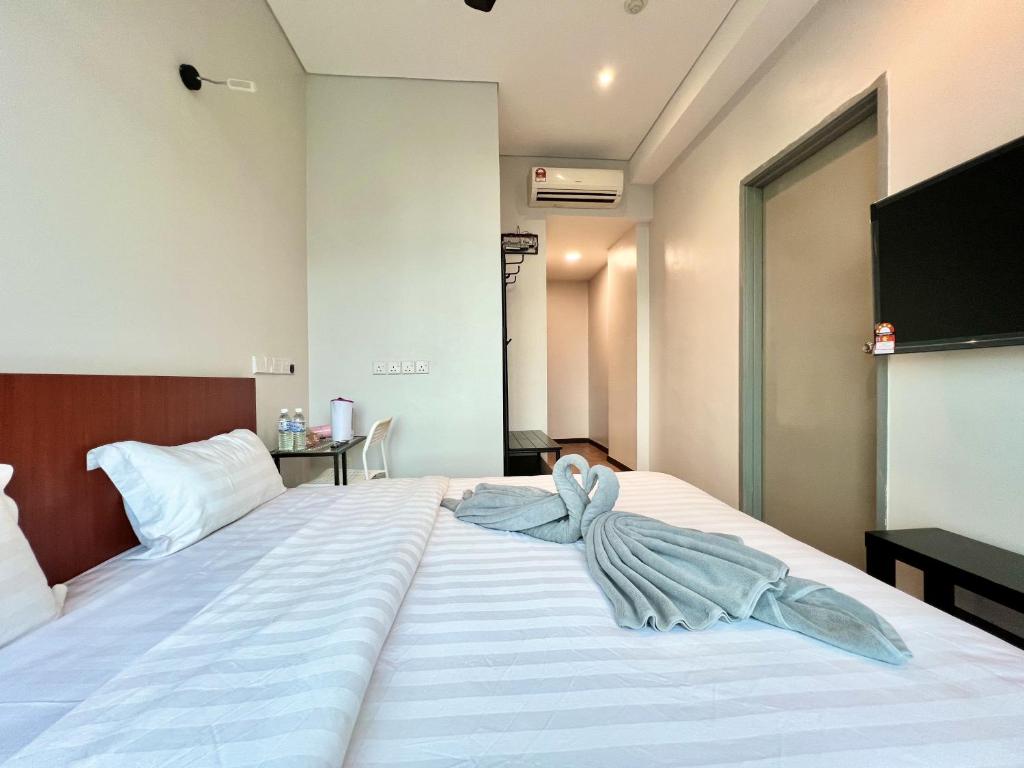 Postel nebo postele na pokoji v ubytování Margo Hotel Kota Kinabalu