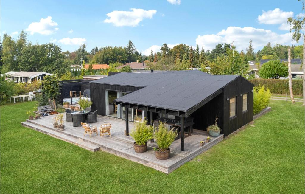 an overhead view of a black house in a yard at Awesome Home In Væggerløse With Kitchen in Marielyst