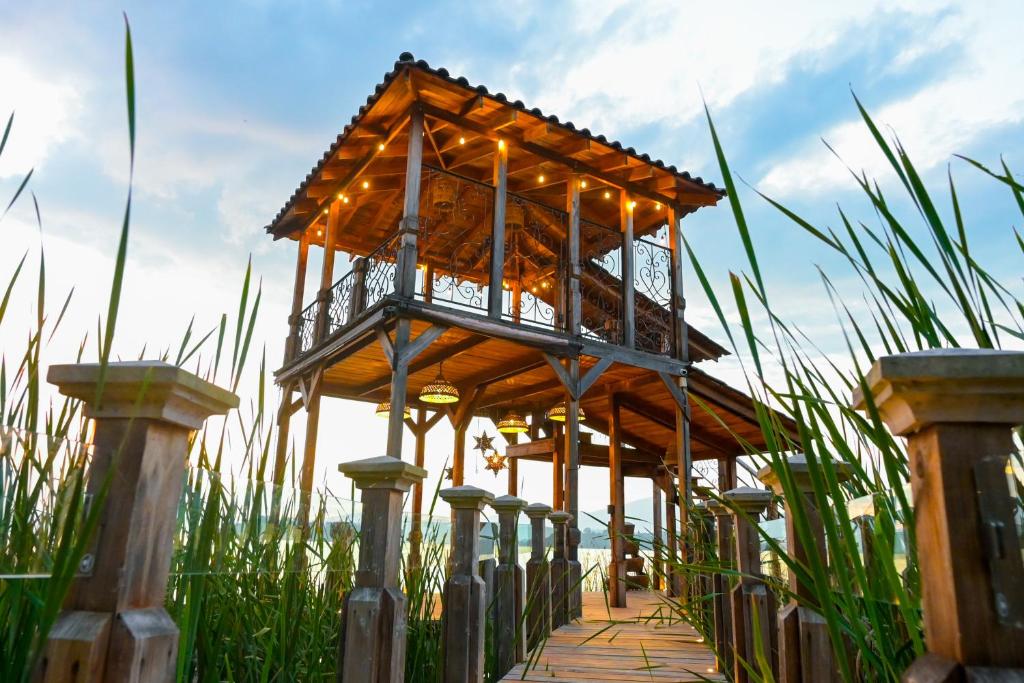 a wooden pavilion in a field of tall grass at Hotel Boutique La Casa Del Lago in Tzintzuntzán