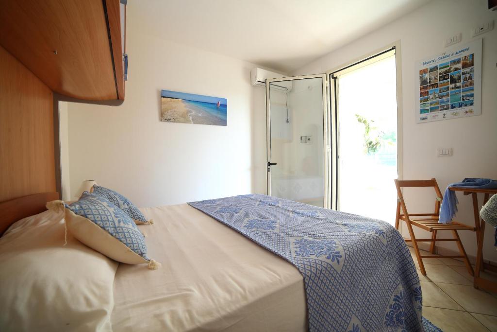 Postel nebo postele na pokoji v ubytování Case vacanza Torre Mozza Ugento Afr0dite