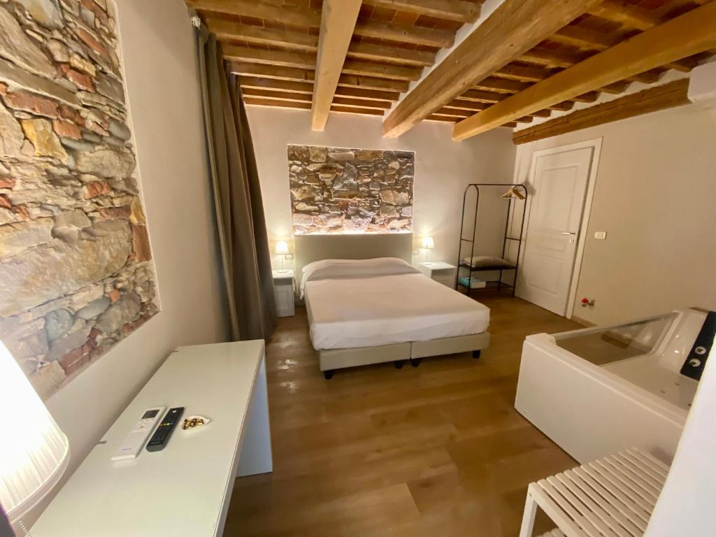 Postel nebo postele na pokoji v ubytování Il Tiglio Jacuzzi&Sauna