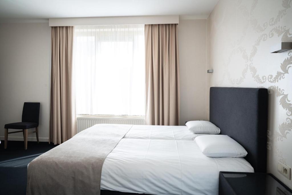 Postel nebo postele na pokoji v ubytování Hotel Essenza