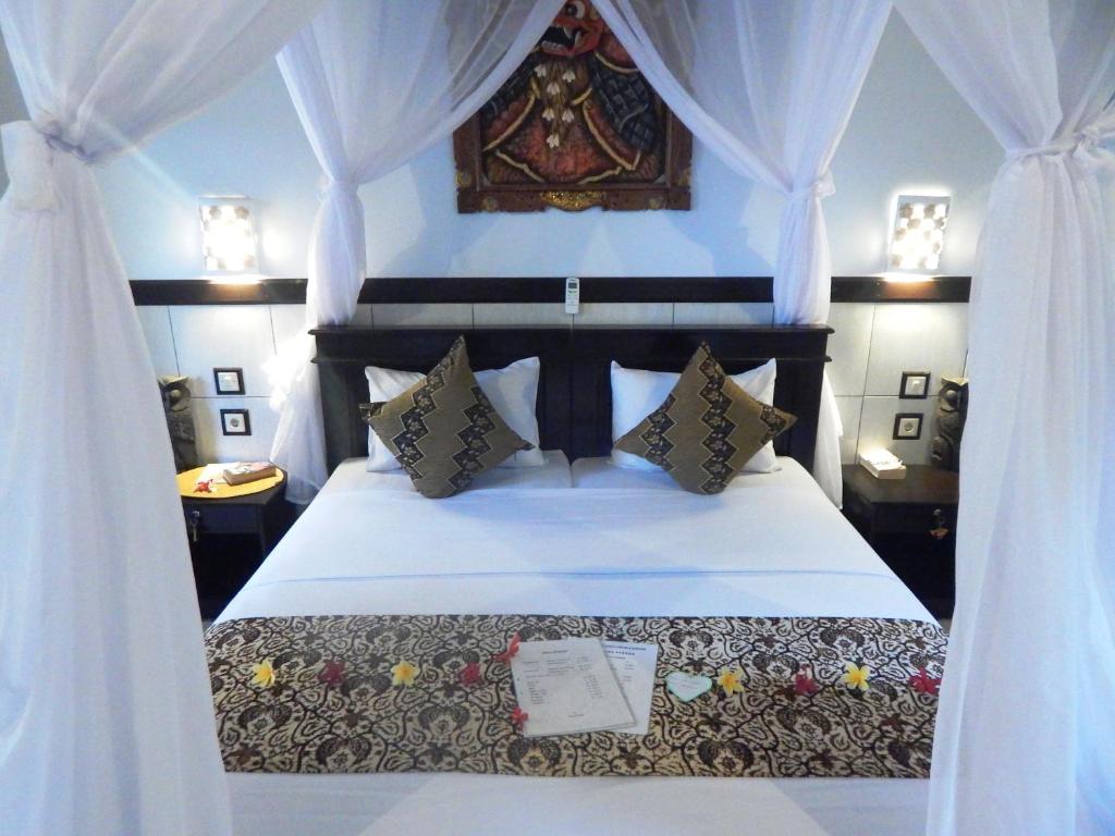 Postel nebo postele na pokoji v ubytování Putu Guest House Pemuteran