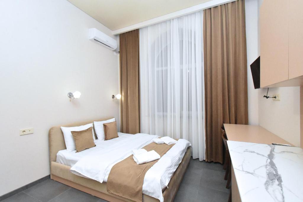 Postel nebo postele na pokoji v ubytování Seva Apart-Hotel Komitas