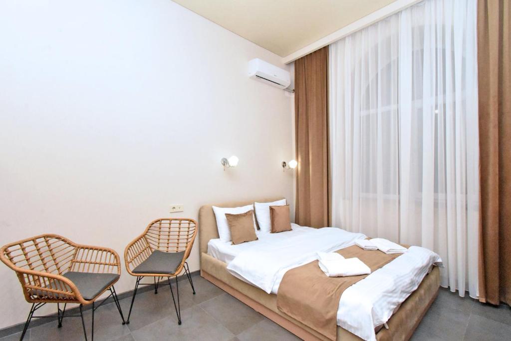Postel nebo postele na pokoji v ubytování Seva Apart-Hotel Komitas