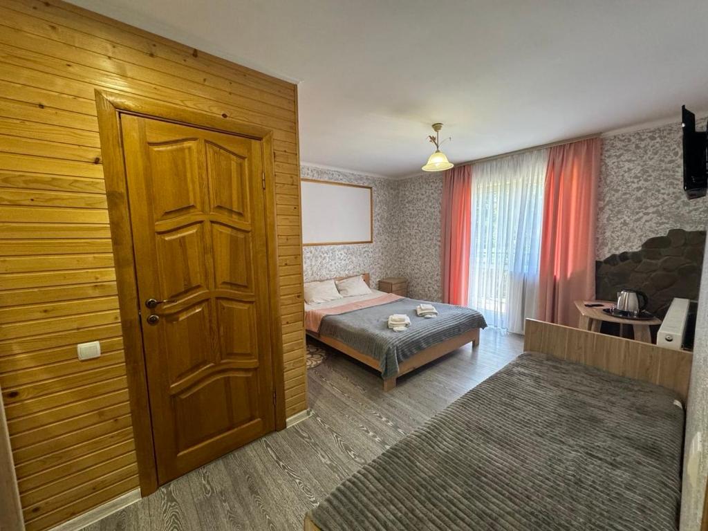 Postel nebo postele na pokoji v ubytování Good House Yaremche