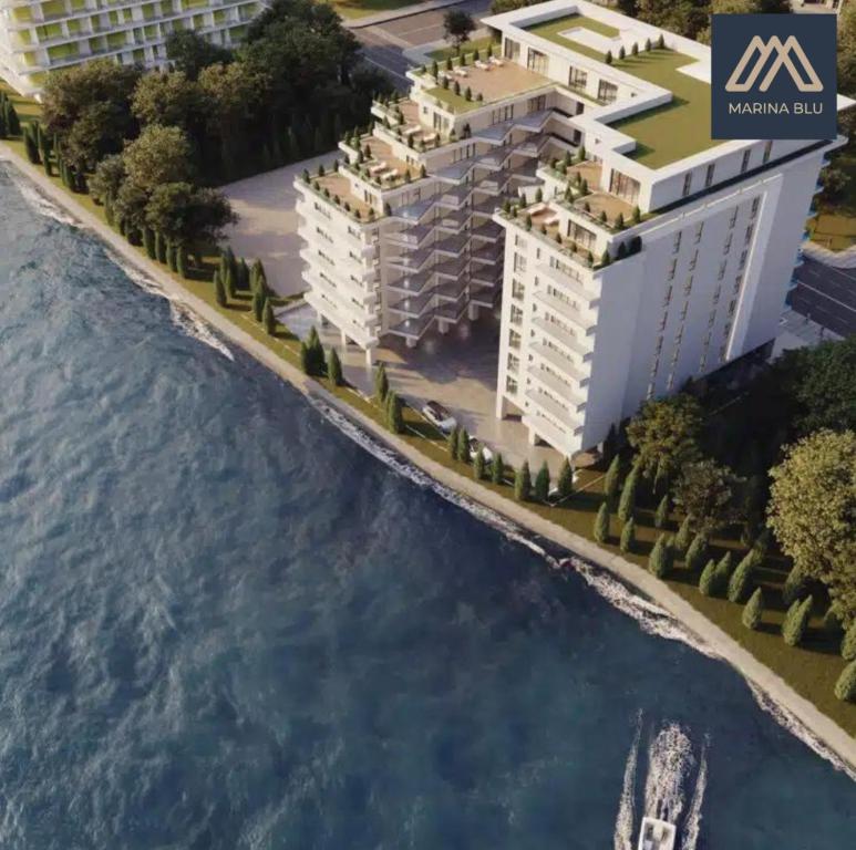 an artist rendering of a proposed apartment complex on the beach at AmyMamaia marina blue in Mamaia