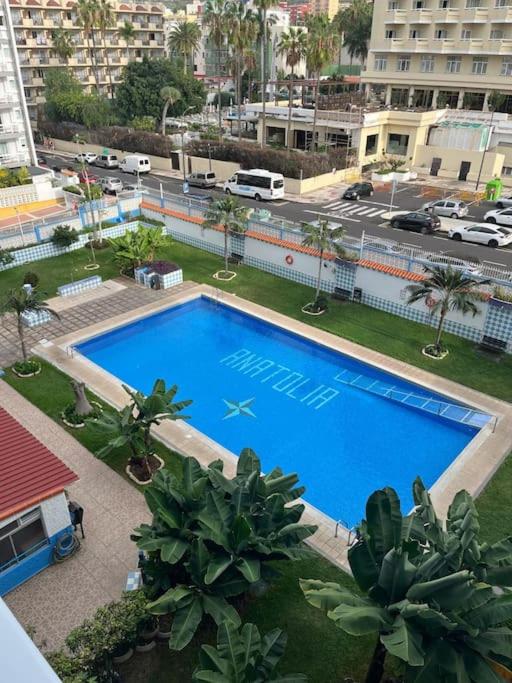 an overhead view of a large swimming pool in a city at Playa Jardín Bus terminal Pool in Puerto de la Cruz