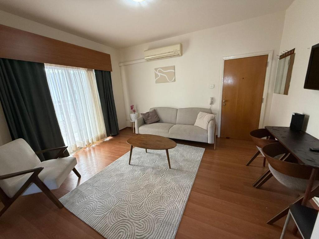 a living room with a couch and a table at Poseidon Breeze in Limassol