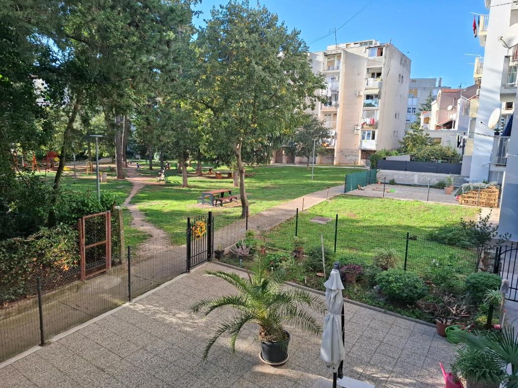 a view of a park with a fence and grass at Apartment Park Melada in Zadar