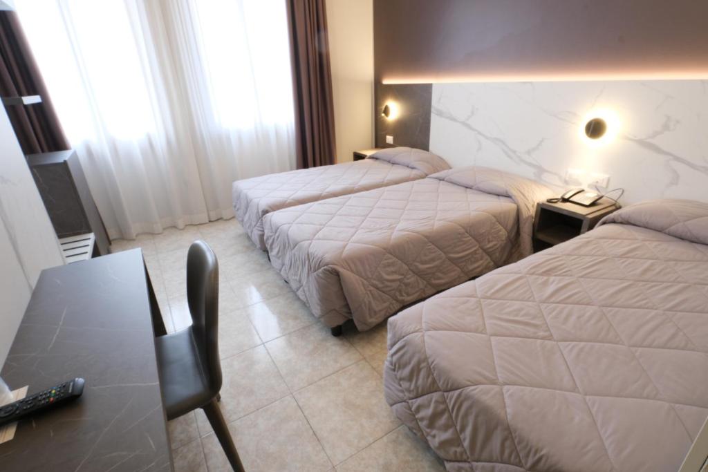 Postel nebo postele na pokoji v ubytování Hotel Mistral