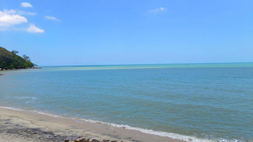 a view of a beach with the ocean at cemetery view homestay in Kota Bharu