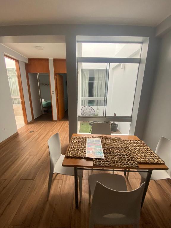 a dining room with a table and chairs in a room at Ravenala - Apartment Paracas in Paracas