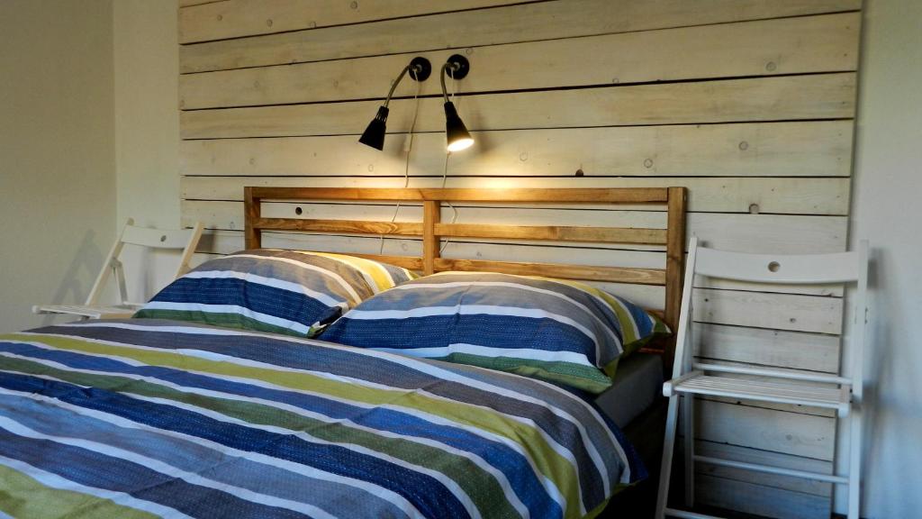 1 dormitorio con 2 camas y pared de madera en Apartment Polianka en Vysoke Tatry - Horny Smokovec