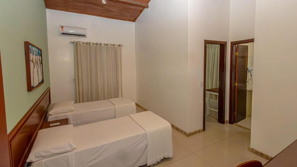 Postel nebo postele na pokoji v ubytování Enseada dos Corais Praia Hotel