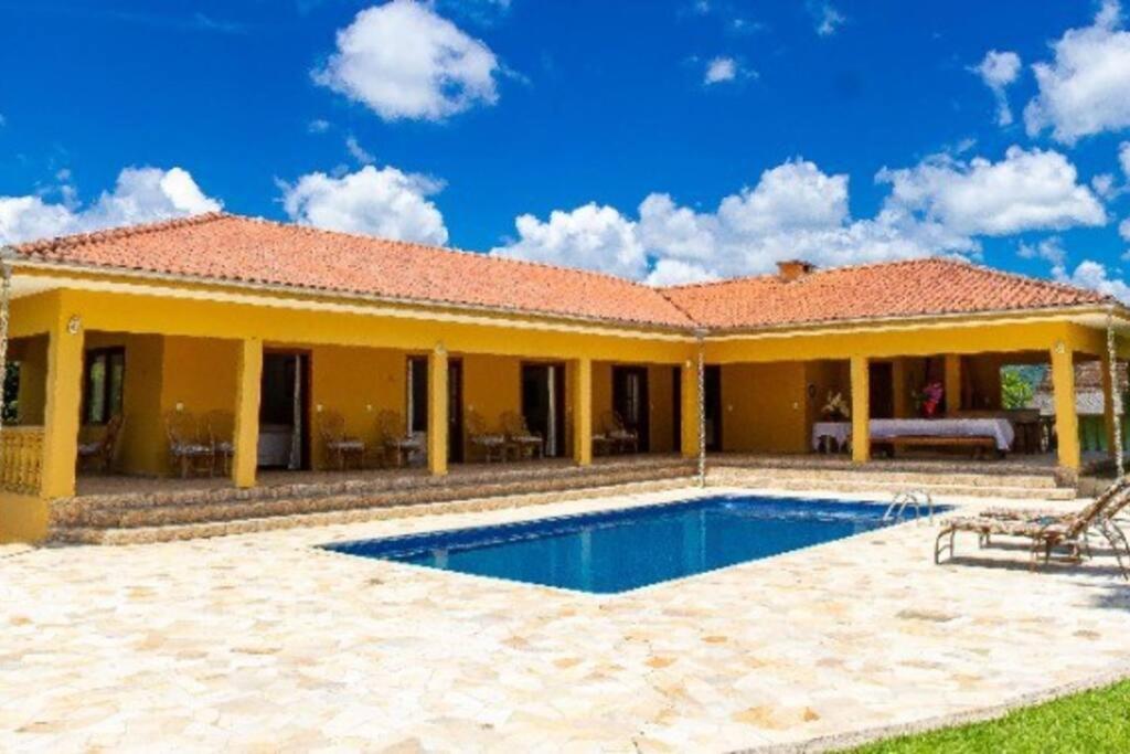 a house with a swimming pool in front of it at Grandhouse Salto Donner in Rio Forcação