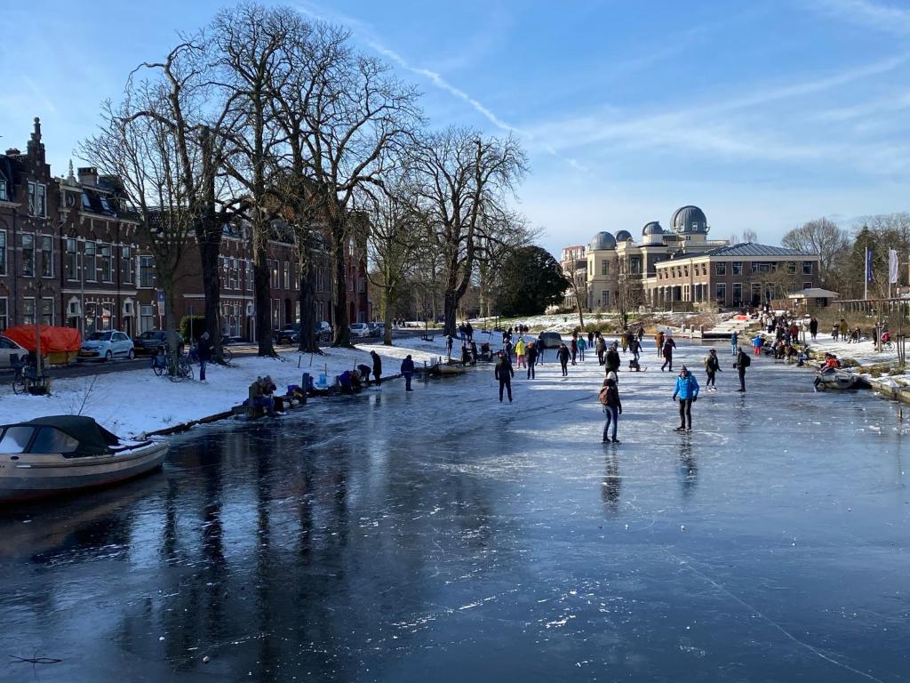 a group of people ice skating on a frozen river at WS77 B&B Apartment in Leiden