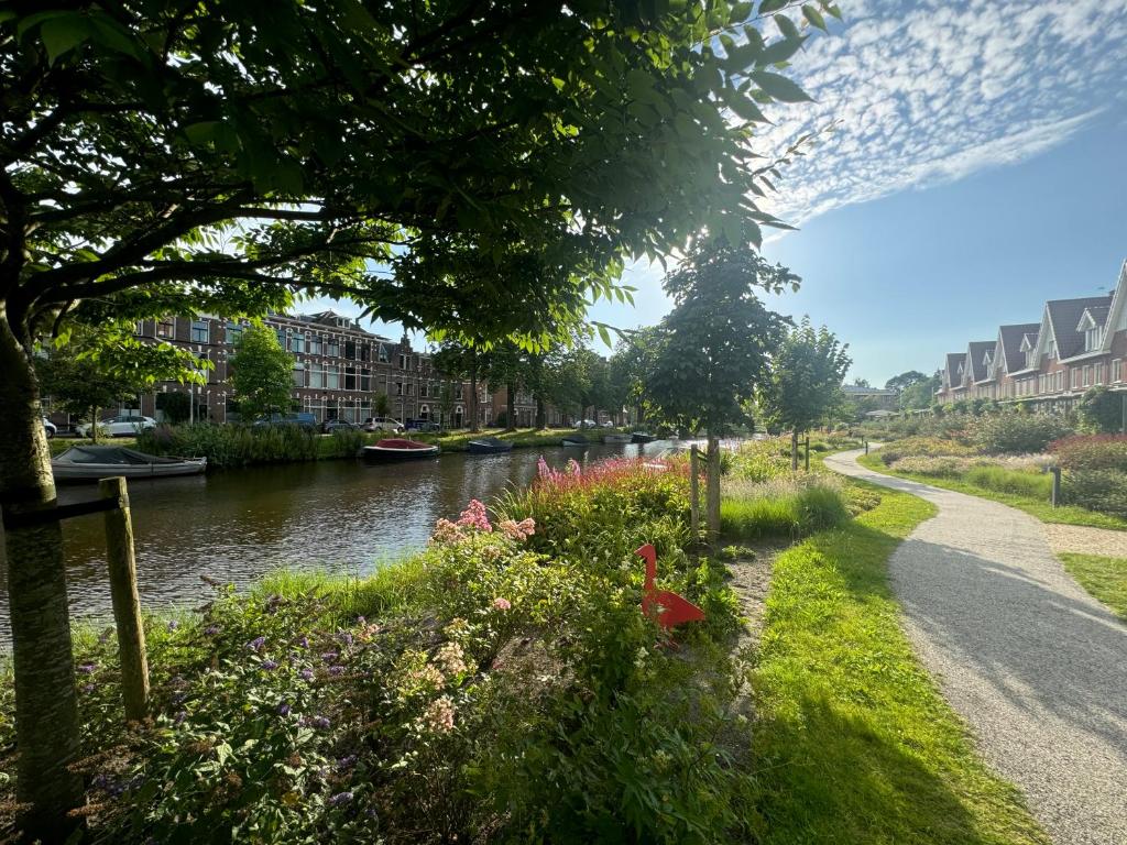 a river with flowers on the side of a road at WS77 B&B Apartment in Leiden