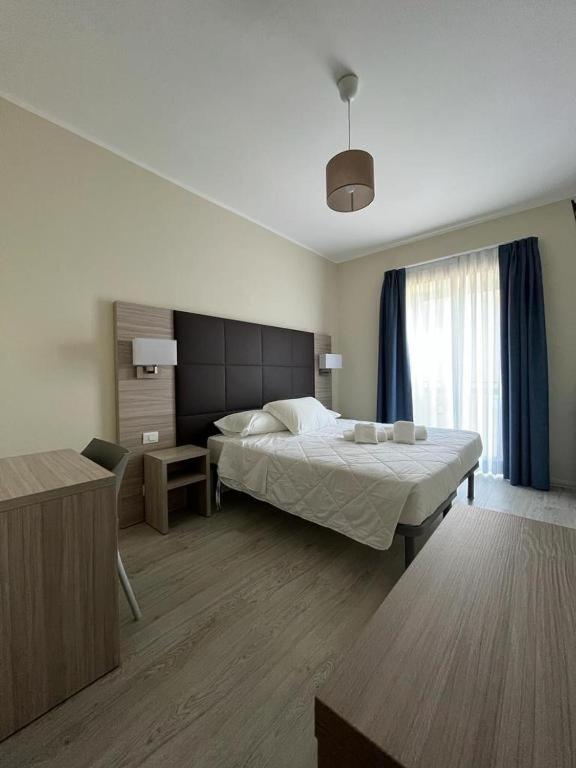 a hotel room with a bed and a window at Adalesia Hotel & Coffee in Turin