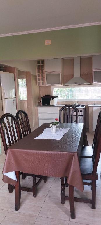 a kitchen with a table and chairs and a table and a kitchen at alojateenazul2024 in Azul