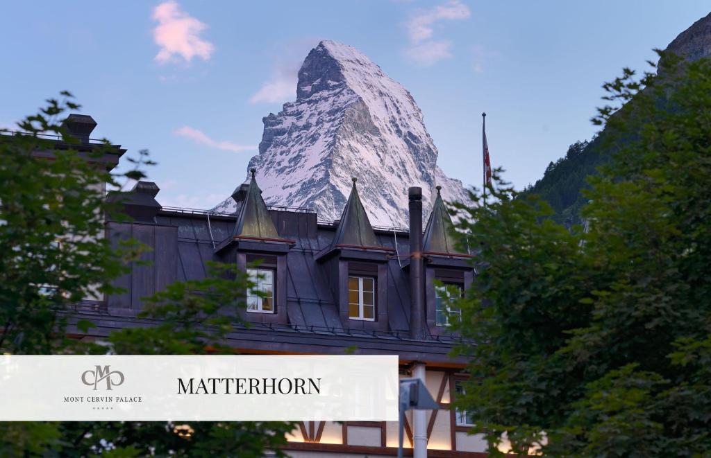 a mountain on top of a building with a sign at Mont Cervin Palace in Zermatt
