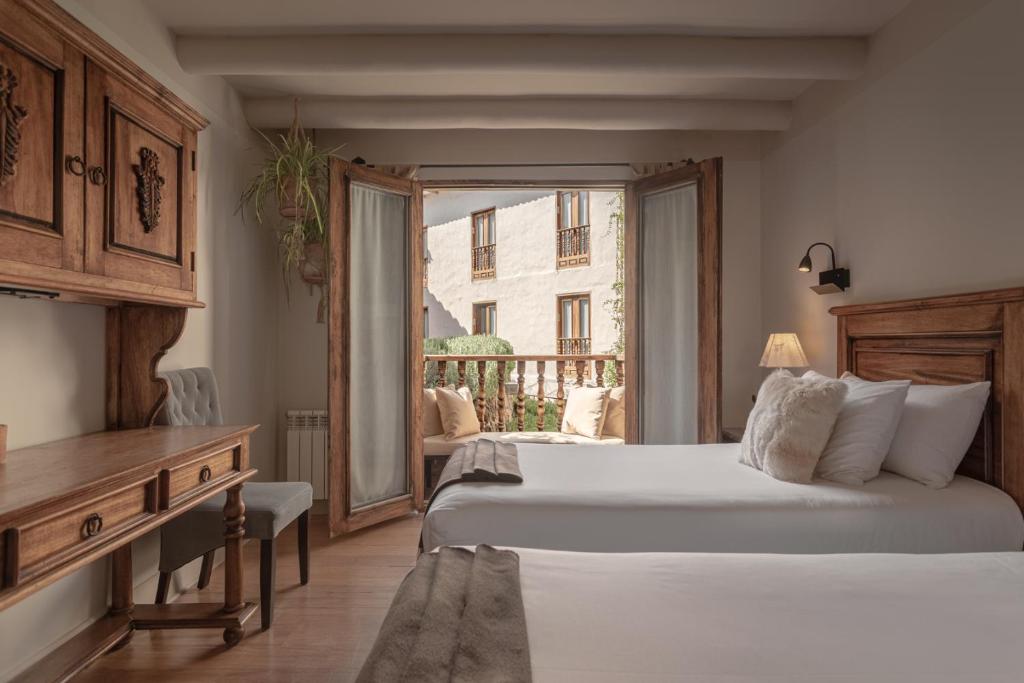 a hotel room with two beds and a window at Antigua Casona San Blas in Cusco